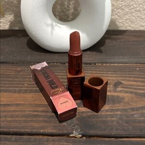 Too Faced Brown Lipstick with White Vase Accent